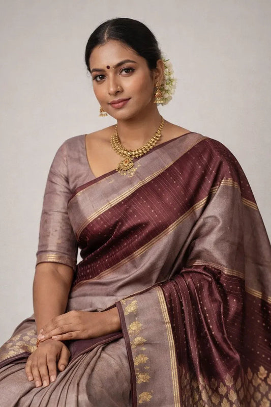 Woman wearing a traditional saree with a plain background